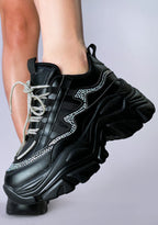 Side angle on-foot shot of the Berness BILLIE Darkwave rhinestone black platform sneakers, highlighting the 2-inch platform height, flexible low-top fit, and reflective rhinestone details along the side panels.