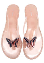 Cape Robbin Blushing Butterfly Jelly Sandals in blush pink PVC, featuring a slip-on thong profile with a sparkling jeweled butterfly accent on the upper strap.
