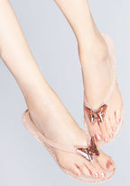 Front view of the blush pink butterfly jelly sandals on-model, showcasing the clear pink straps and the detailed rhinestone embellishments.