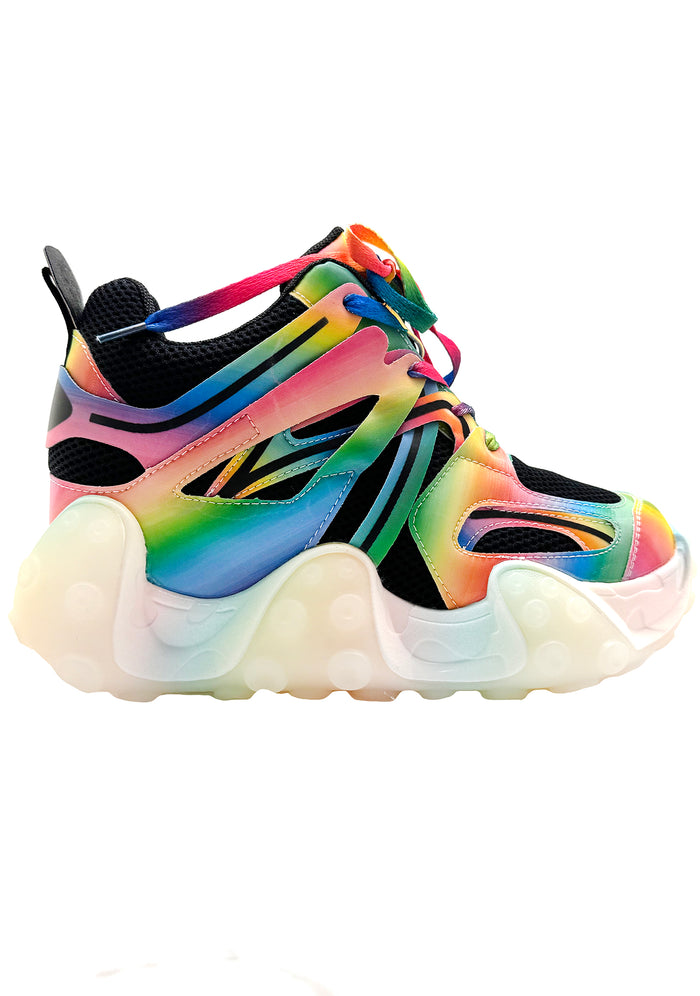 Side studio shot of Anthony Wang CARAMBOLA 03 Virtual Vibrance black platform sneakers showing multi-colored rainbow overlays, lenticular panels, and a wavy pastel-colored platform wedge sole