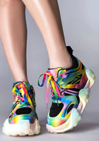 On-foot styling view from behind of Anthony Wang CARAMBOLA 03 Virtual Vibrance platform sneakers highlighting the neon pink, green, and blue wavy tentacle sole design elements