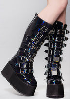 Demonia DAMNED 318 Delusional Dream Hologram Black Platform Boots in iridescent holographic vegan leather with 8 buckle straps worn by model — front view
