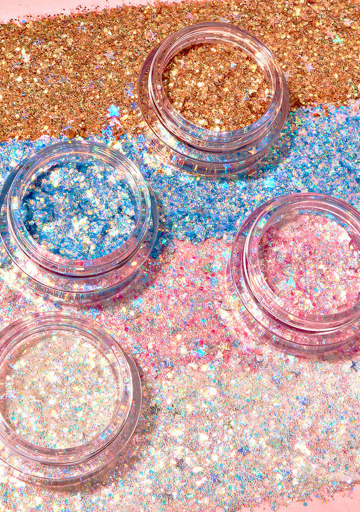 Kimchi Chic GLITTER SHARTS Gel Glitter Pots in 01 Super Galactic blue with holographic star and hexagon glitter in gel pot on rave makeup body glitter — model cheek view