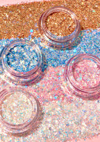 Kimchi Chic GLITTER SHARTS Gel Glitter Pots in 01 Super Galactic blue with holographic star and hexagon glitter in gel pot on rave makeup body glitter — model cheek view
