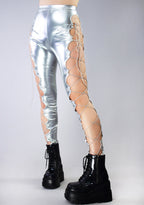 Hot & Delicious Intergalactic Metallic Lace Up Leggings in silver with cut-out lace-up side detail on rave bottoms — model view