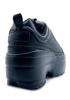 Rear view of the black Berness platform sneakers, detailing the high-profile chunky rubber heel and clean stitched seams.