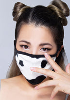 BGlittz Moo Moo Dust Mask in black white with all-over cow print on breathable nylon rave festival face mask — model view