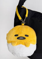 Sanrio Gudetama Die Cut Mini Plush Pouch in yellow white with full-front Gudetama die-cut plush wristlet — model view