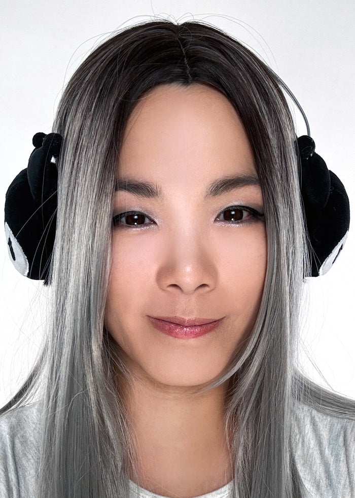 Sanrio Kuromi 3D Plush Earmuff in black with 3D Kuromi plush ear cups on rave festival earmuff accessory — model side view