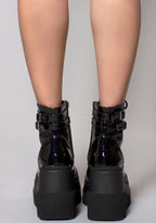 Demonia SHAKER 52 Hologram Black Platform Boots in iridescent holographic vegan leather with double buckled ankle straps worn by model — back view