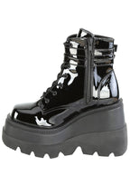 Demonia SHAKER 52 Paint it Black Patent Black Platform Boots in black patent leather showing double buckle ankle strap and lace-up front detail — detail shot