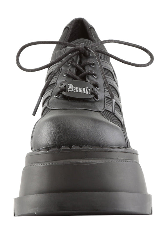 Demonia STOMP 08 Black Rave Platform Sneakers in black vegan leather showing 4.75 inch chunky wedge platform height and traction sole — side view