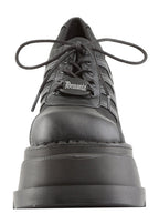 Demonia STOMP 08 Black Rave Platform Sneakers in black vegan leather showing 4.75 inch chunky wedge platform height and traction sole — side view