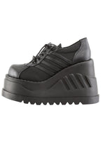 Demonia STOMP 08 Black Rave Platform Sneakers in black vegan leather showing sporty stripe detail and lace-up front closure — detail shot