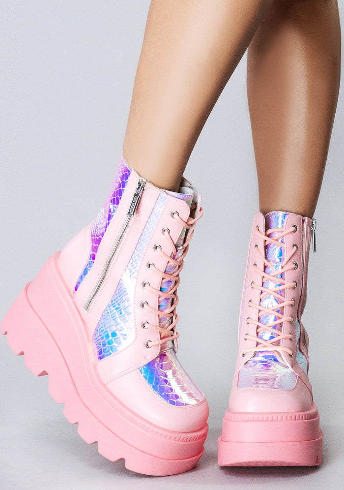 Front view of the pink RADIO rave platform boots on-model, showcasing the matching pink laces, secure metal eyelets, and lightweight chunky combat boot silhouette.