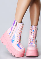 Front view of the pink RADIO rave platform boots on-model, showcasing the matching pink laces, secure metal eyelets, and lightweight chunky combat boot silhouette.