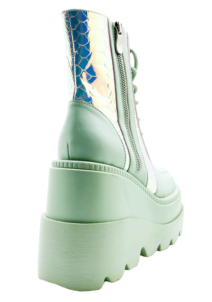 Close-up view of the inner side of the mint green RADIO platform boot, highlighting the convenient side metal zipper closure and the sleek, contoured fit of the sole.